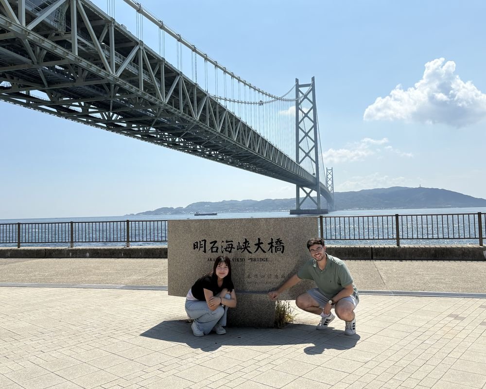 CoKoro guides in front of Akashi Kaikyo Bridge